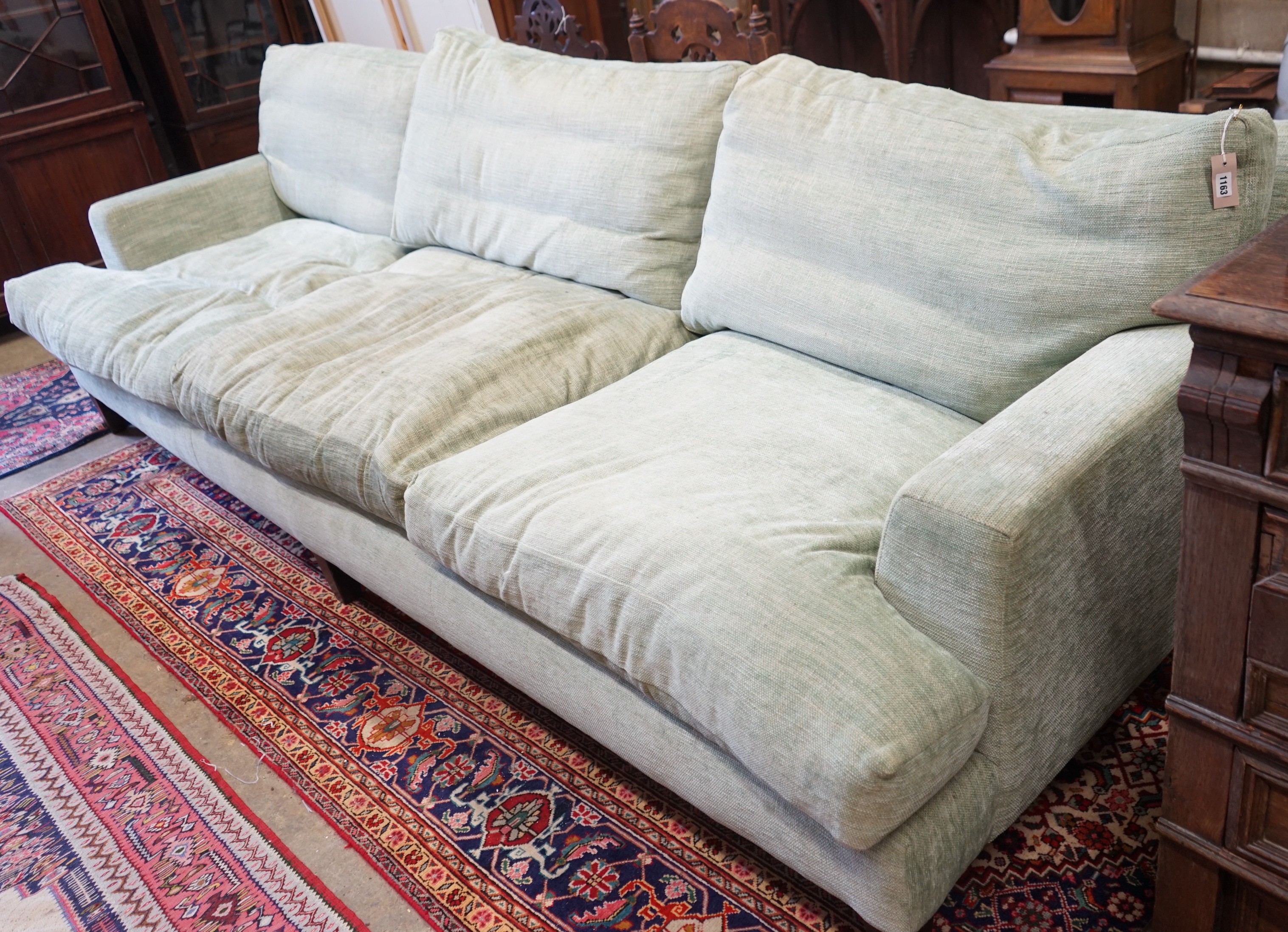 A large Howard style three seater settee upholstered in pale green fabric, length 300cm, depth 120cm, height 92cm